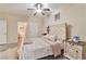 Bright bedroom with a ceiling fan, wooden floors, a bed, and white furniture at 3975 N Hualapai Way # 121, Las Vegas, NV 89129