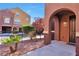 Arched entrance to a beautiful house with lovely landscaping at 3975 N Hualapai Way # 121, Las Vegas, NV 89129