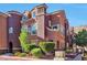 Stylish brown two-story home with well-manicured landscaping and mature trees at 3975 N Hualapai Way # 121, Las Vegas, NV 89129