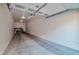 Spacious two car garage featuring concrete floors and white walls and ceiling at 3975 N Hualapai Way # 121, Las Vegas, NV 89129