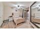 Inviting bedroom with light walls, light wood floors, and a sliding glass door for natural light at 3975 N Hualapai Way # 121, Las Vegas, NV 89129