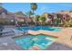 Community pool and hot tub with multiple seating areas surrounded by landscaped plants at 3975 N Hualapai Way # 121, Las Vegas, NV 89129