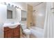 Bathroom featuring a single sink vanity with a tile shower-tub, toilet and medicine cabinet at 409 Antelope Way, Las Vegas, NV 89145