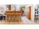 Open kitchen with wooden bar seating, stainless steel appliances, and tile flooring at 409 Antelope Way, Las Vegas, NV 89145