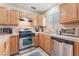 Well-equipped kitchen with stainless steel appliances, tile backsplash, and light wood cabinets at 409 Antelope Way, Las Vegas, NV 89145