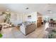 Open-concept living room featuring tile floors, a bar area, and access to the dining room and kitchen at 409 Antelope Way, Las Vegas, NV 89145