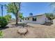 Spacious backyard with mature trees and a tree stump, offering ample room for outdoor activities at 4424 Sunrise Ave, Las Vegas, NV 89110