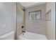 Updated bathroom boasts stylish tile work around the tub-shower combo and a bright window at 4424 Sunrise Ave, Las Vegas, NV 89110