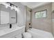 Modern bathroom features sleek vanity, updated fixtures, and a tiled shower-over-tub with a window at 4424 Sunrise Ave, Las Vegas, NV 89110