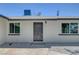Front door view of a home with two windows and a gravel yard at 4424 Sunrise Ave, Las Vegas, NV 89110