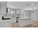Modern white kitchen featuring stainless steel appliances, quartz countertops, and a central island at 4424 Sunrise Ave, Las Vegas, NV 89110