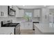 Bright kitchen with white cabinets, stainless steel appliances, and quartz countertops at 4424 Sunrise Ave, Las Vegas, NV 89110