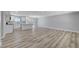 Bright living room with wood floors connects to a modern, white kitchen with stainless steel appliances at 4424 Sunrise Ave, Las Vegas, NV 89110