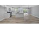 Open-concept living area features modern white kitchen with island and stainless appliances; seamless flow to backyard at 4424 Sunrise Ave, Las Vegas, NV 89110