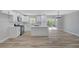 Open-concept living area features modern white kitchen with island and stainless appliances; seamless flow to backyard at 4424 Sunrise Ave, Las Vegas, NV 89110
