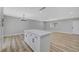 Open-concept living room with an island, wood-look floors, and natural light at 4424 Sunrise Ave, Las Vegas, NV 89110