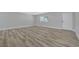 Bright and airy living area features wood-look floors and a door that leads to the exterior of the home at 4424 Sunrise Ave, Las Vegas, NV 89110