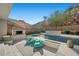 A private pool with a sun shelf, water features, desert landscape, and an outdoor television at 5 Highland Cove Ln, Henderson, NV 89011