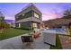 Contemporary backyard with a pool, lush lawn, fire pit, and stylish patio for ultimate outdoor living at 5 Highland Cove Ln, Henderson, NV 89011