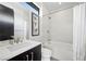 This is a full bathroom with a shower-tub combo, modern vanity, and tiled wall at 5 Highland Cove Ln, Henderson, NV 89011