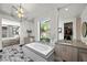 Luxurious bathroom with a soaking tub, double vanities, and elegant fixtures at 5 Highland Cove Ln, Henderson, NV 89011