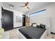 This modern bedroom has natural light, sleek hardwood flooring, and a decorative ceiling fan at 5 Highland Cove Ln, Henderson, NV 89011