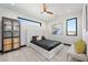 This modern bedroom features natural light, a ceiling fan, hardwood flooring, and stylish decorations at 5 Highland Cove Ln, Henderson, NV 89011