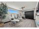 Bright bonus room featuring sleek wood floors, modern exercise equipment, and a decorative wall at 5 Highland Cove Ln, Henderson, NV 89011