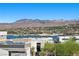 Beautiful community view with the lake and mountains in the background on a sunny day at 5 Highland Cove Ln, Henderson, NV 89011