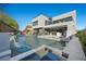 A modern home features multiple balconies and an inviting backyard pool at 5 Highland Cove Ln, Henderson, NV 89011
