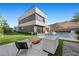 Striking modern home featuring clean lines, a lush backyard, and a luxurious pool with a fire feature at 5 Highland Cove Ln, Henderson, NV 89011