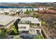 Aerial view of a modern home with a rooftop deck, balcony, pool, and beautifully landscaped yard at 5 Highland Cove Ln, Henderson, NV 89011