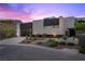 Contemporary home showcasing clean lines, a glass garage door, and desert landscaping at 5 Highland Cove Ln, Henderson, NV 89011