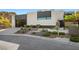 Contemporary home exterior with a glass garage door, modern landscaping, and a stylish walkway at 5 Highland Cove Ln, Henderson, NV 89011