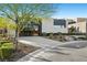 Modern home with glass garage door, a concrete driveway, and manicured landscaping at 5 Highland Cove Ln, Henderson, NV 89011