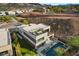 Modern home with a rooftop deck, balcony, pool, and lush landscaping at 5 Highland Cove Ln, Henderson, NV 89011
