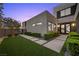 Modern home with a well-manicured front lawn, concrete pathway, and stylish landscaping at 5 Highland Cove Ln, Henderson, NV 89011