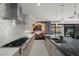 Gourmet kitchen featuring stainless steel appliances, stone countertops, and designer finishes with cooktop at 5 Highland Cove Ln, Henderson, NV 89011