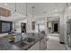 Contemporary kitchen boasts stone countertops, custom cabinets, and stainless steel appliances with island at 5 Highland Cove Ln, Henderson, NV 89011