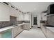 Bright kitchen with custom cabinets, stainless appliances, with gray accent backsplash at 5 Highland Cove Ln, Henderson, NV 89011