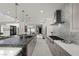 Sleek kitchen with a waterfall island, stainless steel appliances, and stylish pendant lighting at 5 Highland Cove Ln, Henderson, NV 89011