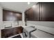 Laundry room with stainless steel washer and dryer, quartz countertop and custom cabinets at 5 Highland Cove Ln, Henderson, NV 89011