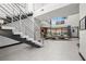 Bright living room with soaring ceilings, a modern staircase, and seamless indoor-outdoor living at 5 Highland Cove Ln, Henderson, NV 89011