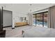 Bright main bedroom with sliding glass door to the pool, modern cabinets and chandelier at 5 Highland Cove Ln, Henderson, NV 89011