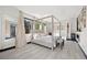 This spacious main bedroom features natural light, modern decor, and light colored, wide plank floors at 5 Highland Cove Ln, Henderson, NV 89011