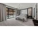 Elegant main bedroom featuring a chandelier, sliding glass doors, and modern accents at 5 Highland Cove Ln, Henderson, NV 89011