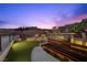 This outdoor kitchen features modern appliances, stylish bench seating, and amazing desert scenery at 5 Highland Cove Ln, Henderson, NV 89011