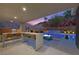 Inviting outdoor kitchen and bar area with a built-in grill, fire pit and view of the pool at 5 Highland Cove Ln, Henderson, NV 89011