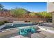 An inviting backyard pool with desert landscaping and an adjacent sun-bathing space at 5 Highland Cove Ln, Henderson, NV 89011