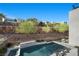 Backyard pool featuring a spa and waterfall, offering a serene oasis with stunning hillside views at 5 Highland Cove Ln, Henderson, NV 89011